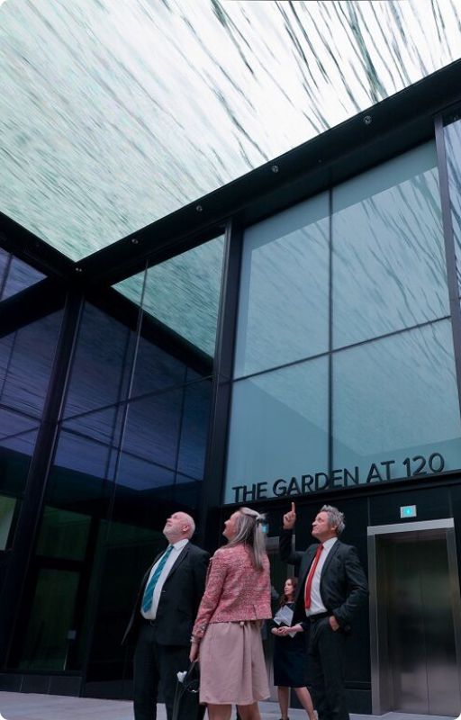 High level working professionals standing in front of an office building